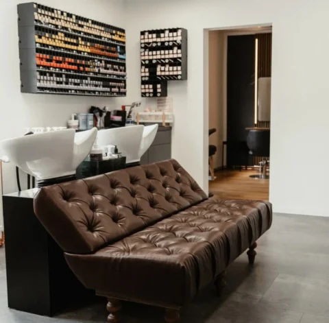 Friseur HairConcept Stockheim – moderner Waschplatz mit Ledersofa im Salon